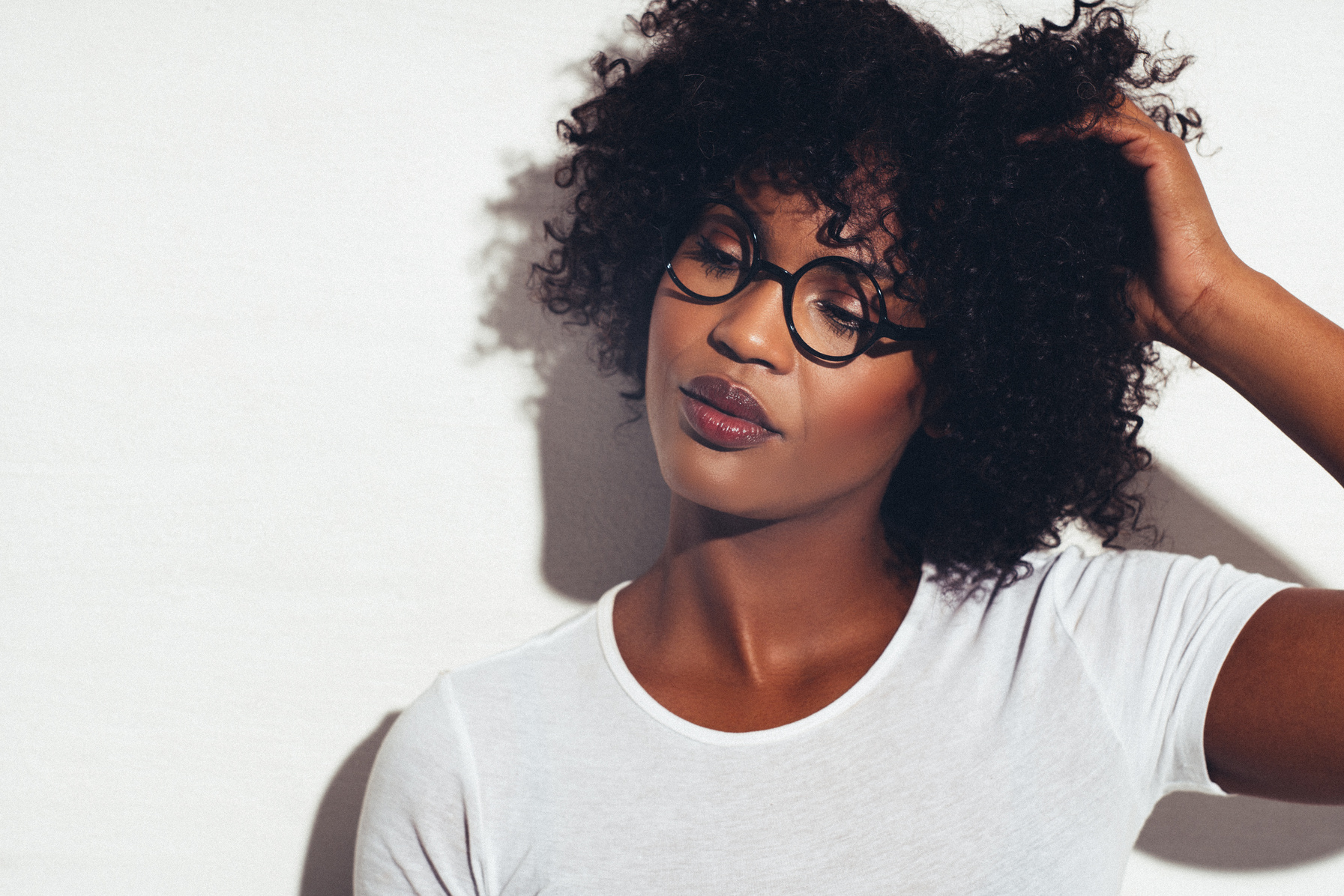 Attractive African Woman Standing with a Hand in Her Hair